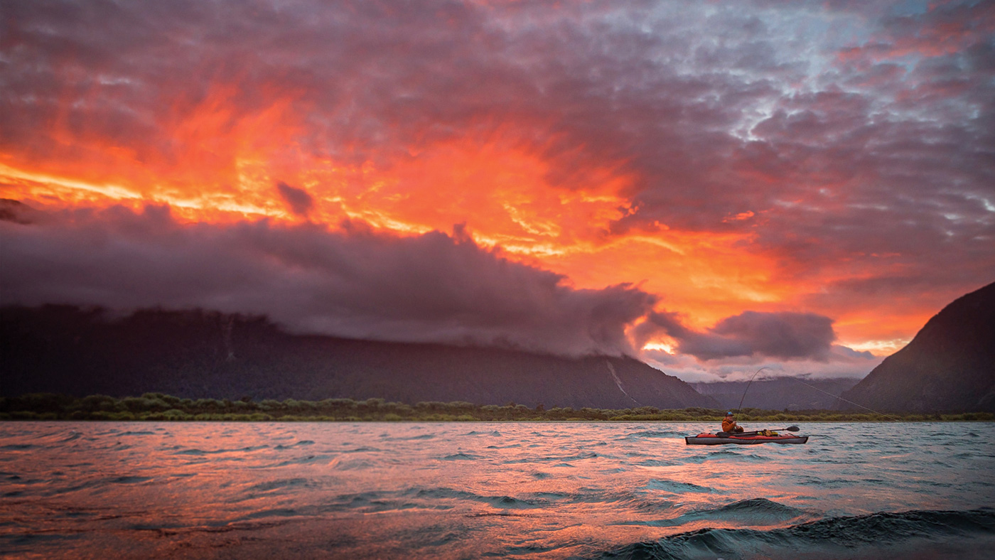 Fly Fishing Photography Portfolio Patagonia lake kayaking sunset fire in the sky